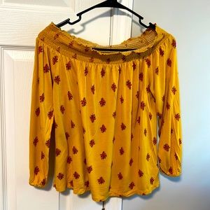 Gold off the shoulders top with pink flowers print.